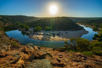 sun over horseshoe bend, kalbarri national park, western australia 6