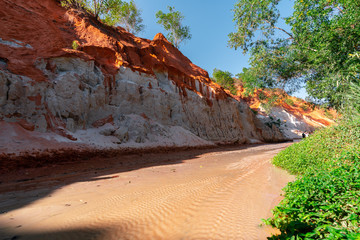 Fairy Stream Canyon. Red river between rocks and jungle. Mui Ne. Vietnam