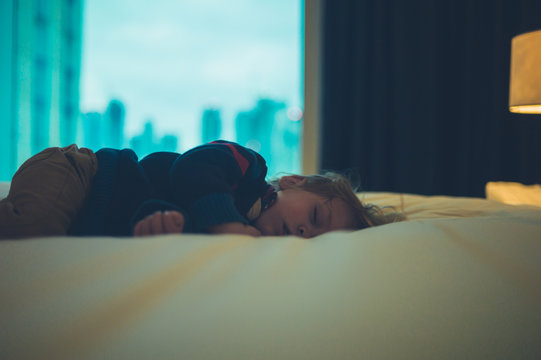 Toddler sleeping in the city
