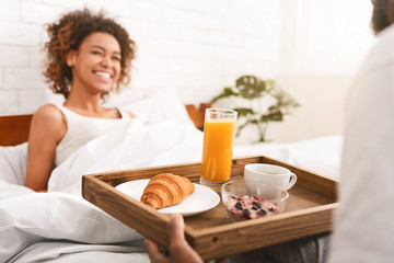 Boyfriend bring some breakfast to his girlfriend in bed - obrazy, fototapety, plakaty