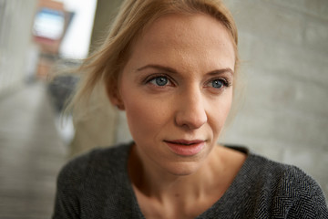 Beautiful young caucasian business woman using a mobile phone and laptop in various urban settings, shot in Copenhagen, Denmark