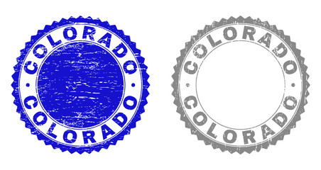 Grunge COLORADO stamps isolated on a white background. Rosette seals with grunge texture in blue and grey colors. Vector rubber stamp imitation of COLORADO title inside round rosette.