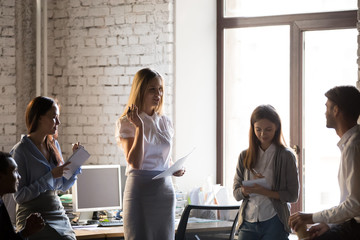 Millennial businesswoman hold meeting with colleagues in office