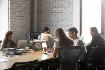 Diverse employees busy working in shared office