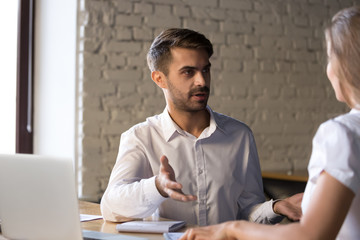 Diverse colleagues have conversation discussing business project