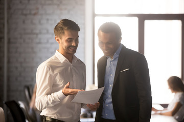 Excited employee show financial statistics to happy boss