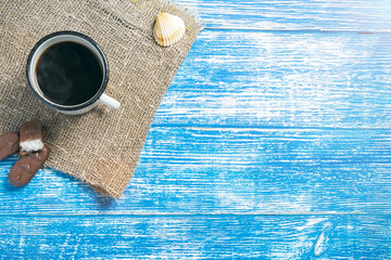 Blue aged wooden background for billets and design with old cloth from the bottom and a cup of...