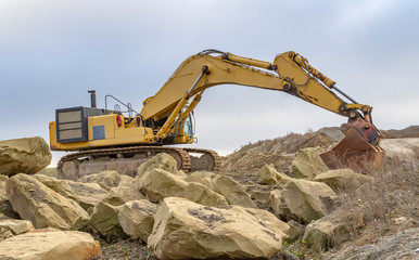 Excavator in stony ambiance