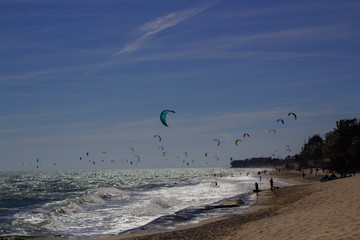 Kiteboarding, itesurfing at sunset in Mui Ne beach, Vietnam Phan Thiet