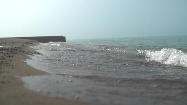 Calm waves crash along the shoreline.