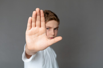 Boy showing stop gesture with his hand
