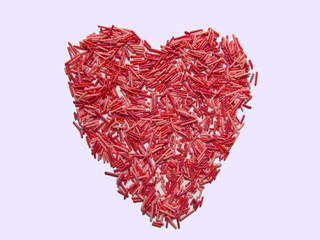 Fototapeta na wymiar Red heart on Pink backgrounds, Valentine's Day love concept. Red heart made of small pink and red sticks. St. Valentine's Day concept background.