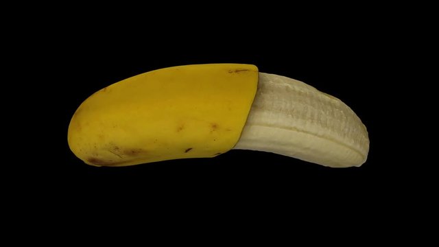 Realistic render of a rotating half peeled banana (Cavendish variety) on black background. The video is seamlessly looping, and the object is 3D scanned from a real banana.