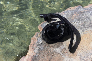 Black mask and snorkel for scuba diving by the sea