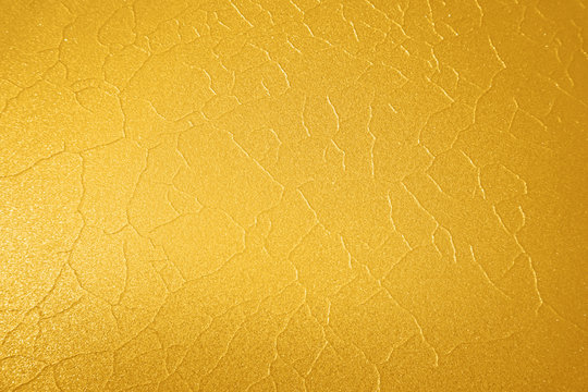 yellow orange gold abstract background preparation of ice and snow with cracks, folds, texture like leather for design, cards, screensavers, smartphones, phones, mobile