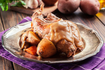 Stewed rabbit legs with vegetables