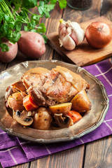 Stewed rabbit legs with vegetables