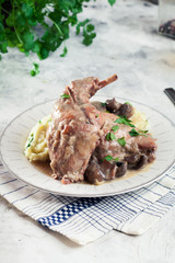 Stewed rabbit legs with vegetables