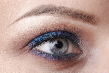 Fototapeta na wymiar beautiful blue eye close - up, bright make-up