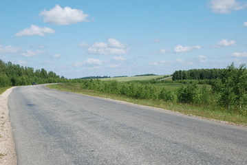 Fototapeta premium Light blue sky and white clouds above the road