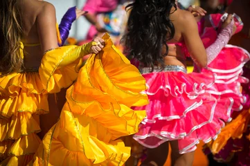 Poster Sunny close-up of the colorful ruffled dresses of Carnival costumes dancing in bright sunlight in Rio de Janeiro, Brazil © lazyllama