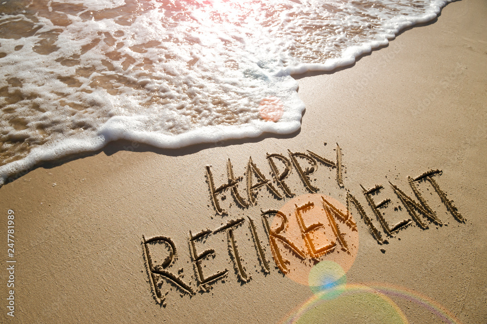 Wall mural Happy Retirement message handwritten on smooth sand beach with gentle wave