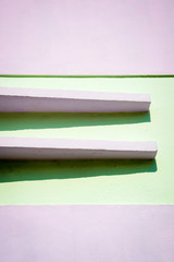 Abstract architectural background of a geometric detail casting shadows on the exterior of a pastel colored Art Deco building in bright sun in South Beach, Miami, Florida, USA