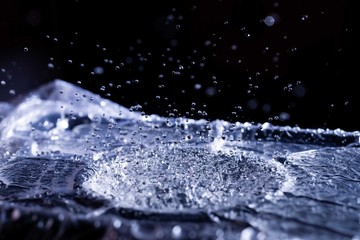 Water drops splashing on acoustic membrane. A lot of drops in air. High frequency of sound waves. Water cloud small drops. Frozen time shot.