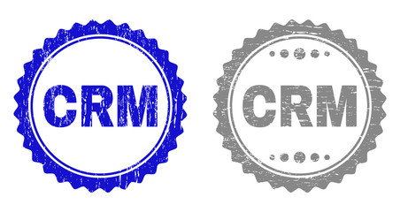 Grunge CRM stamp seals isolated on a white background. Rosette seals with grunge texture in blue and grey colors. Vector rubber stamp imitation of CRM title inside round rosette.