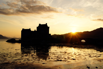 Fototapeta na wymiar Eilean Donan Castle at sunset with some reflections in the water