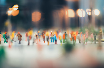 miniature people walking on streets,people are moving across the pedestrian crosswalk in the city...