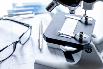 doctors desk with microscope and test tubes