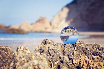 View of mediterranean sea through a glass ball, holiday time. Through a glass ball