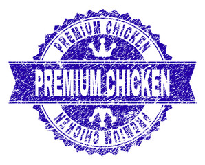 PREMIUM CHICKEN rosette stamp imitation with distress style. Designed with round rosette, ribbon and small crowns. Blue vector rubber print of PREMIUM CHICKEN caption with retro style.