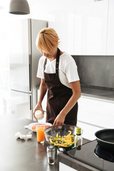 Attractive woman cooking lunch