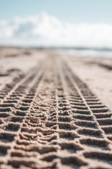 Leading sand tracks tyre trail on a beach in the Netherlands, Brouwersdam with beautiful texture
