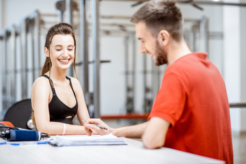 Young woman during the medical consultation with rehab at the rehabilitation gym