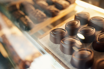 Pieces of chocolate sitting in a confectionary shop display case