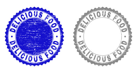 Grunge DELICIOUS FOOD watermarks isolated on a white background. Rosette seals with grunge texture in blue and gray colors. Vector rubber stamp imitation of DELICIOUS FOOD text inside round rosette.