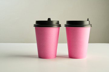 Paper coffee disposable cup for take away or to go, wooden table, space for design mock-up.