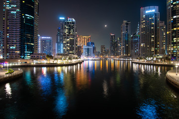 Fototapeta na wymiar Dubai, United Arab Emirates - October, 2018: Colorful city lights at night time in Dubai Marina, United Arab Emirates