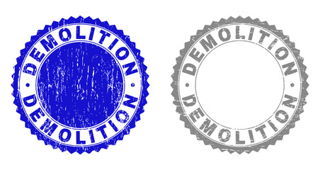 Grunge DEMOLITION stamp seals isolated on a white background. Rosette seals with grunge texture in blue and gray colors. Vector rubber stamp imitation of DEMOLITION tag inside round rosette.