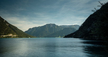 the still lake of achensee in the tyrol region of austria in europe during a clear bright calm summer day
