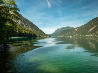 Fototapeta na wymiar the still lake of achensee in the tyrol region of austria in europe during a clear bright calm summer day