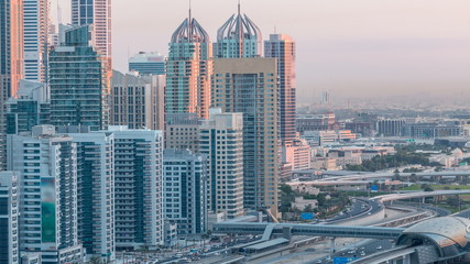 Dubai Marina skyscrapers aerial top view before sunrise from JLT in Dubai night to day timelapse, UAE.