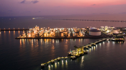 Fototapeta premium Oil and Gas terminal is industrial facility for storage of oil, gas and petrochemical products, Aeria view at twilight.