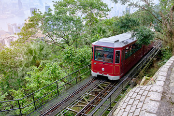 Naklejka premium Victoria Peak Tram and unidentified people with Hong Kong city skyline background. landmark and destination for tourist attractions in HK