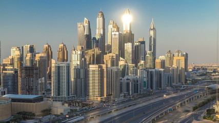 Naklejka na ściany i meble Dubai Marina towers during sunset aerial timelapse, United Arab Emirates