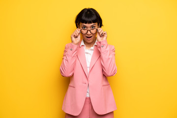 Modern woman with pink business suit with glasses and surprised