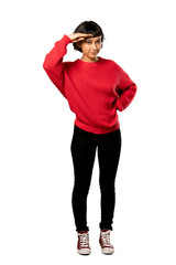 A full-length shot of a Short hair girl with red sweater looking far away with hand to look something over isolated white background
